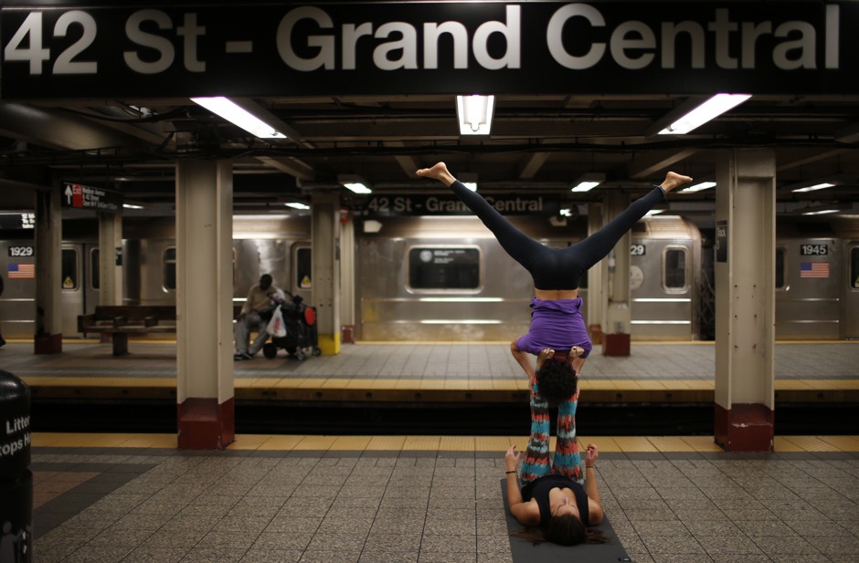 Lauren Tallody (bottom) and Bassam Kubba (top) practice &quot;Acro-yoga&quot;, a mixture of yoga and acrobatics on a subway platform at 42nd Street beneath Grand Central station in New York city