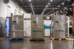 Whirlpool Corp. refrigerators sit on paletts at a distribution center in Wilmer, Texas, U.S., on Thursday, Dec. 27, 2018. J.B. Hunt Transport Services Inc. is announcing Wednesday that it has agreed to pay $100 million for a New Jersey company that delivers large items to consumers, its second purchase in the space in less than two years.