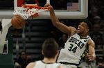 Milwaukee Bucks' Giannis Antetokounmpo dunks during the first half of an NBA basketball game against the Charlotte Hornets Wednesday, Dec. 1, 2021, in Milwaukee. (AP Photo/Morry Gash)