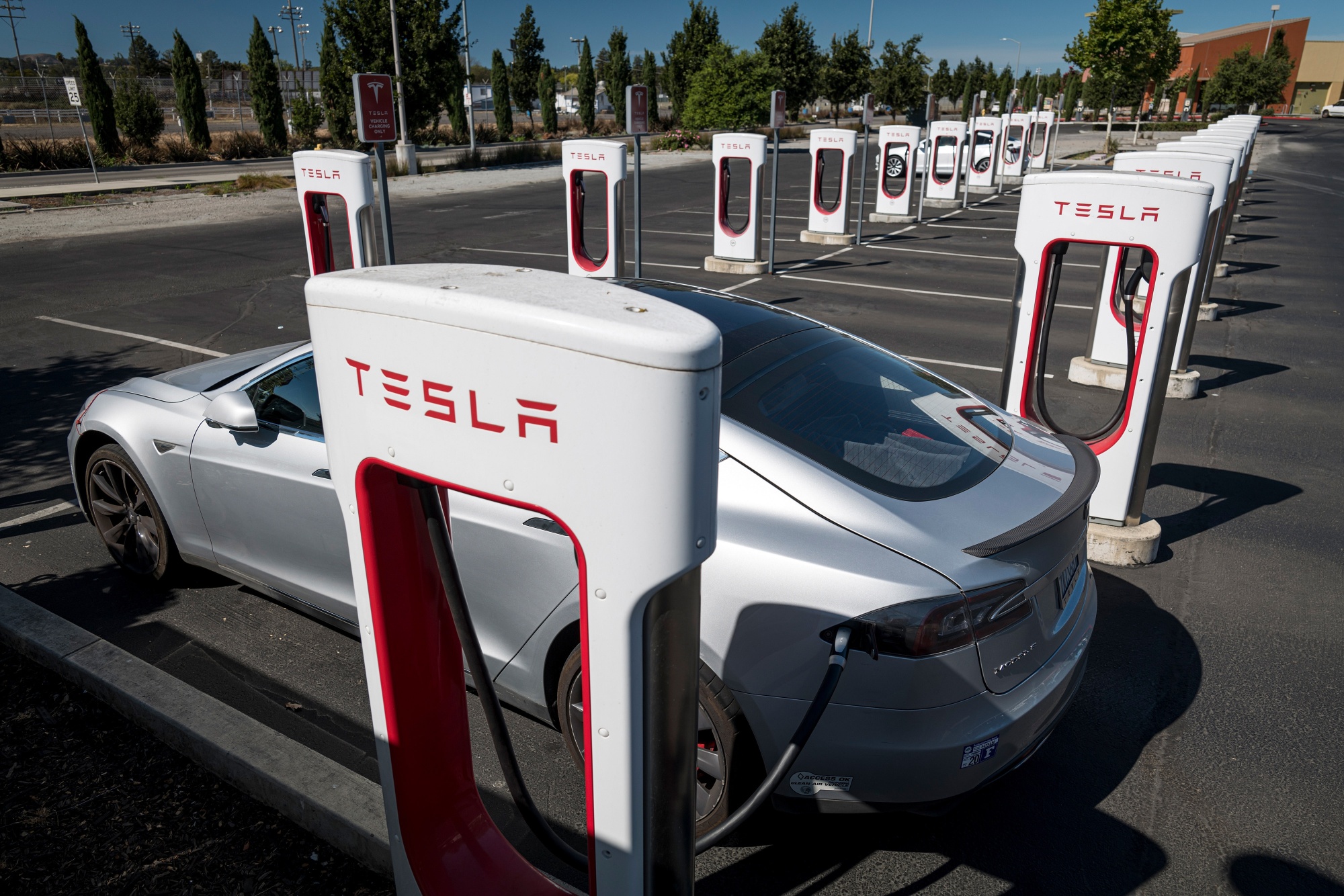 A Tesla Inc. vehicle charging at a Tesla Supercharger station in Petalama, California.