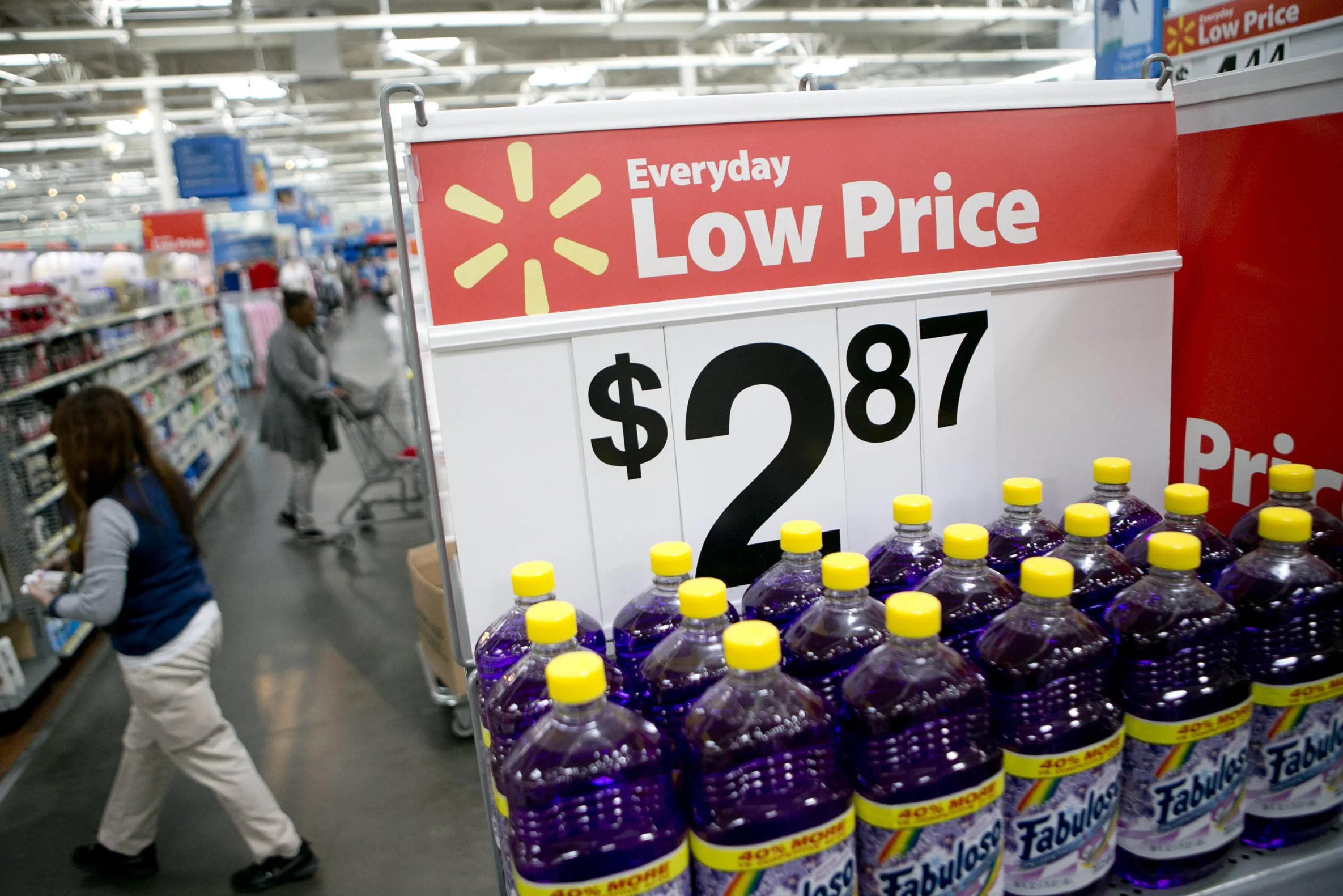 Bottles of multi-purpose cleaner sit on display next to a low price sign at a Wal-Mart store in Alexandria, Virginia, U.S., on Wednesday, Nov. 14, 2012.&nbsp;