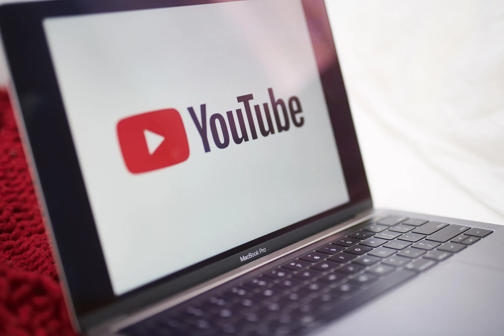 The logo for YouTube Inc. is displayed on a laptop computer.