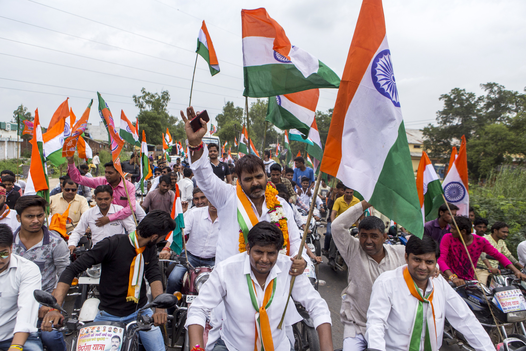Bharatiya Janata Party (BJP) members and supporters carry India national flags during a&nbsp;rally.