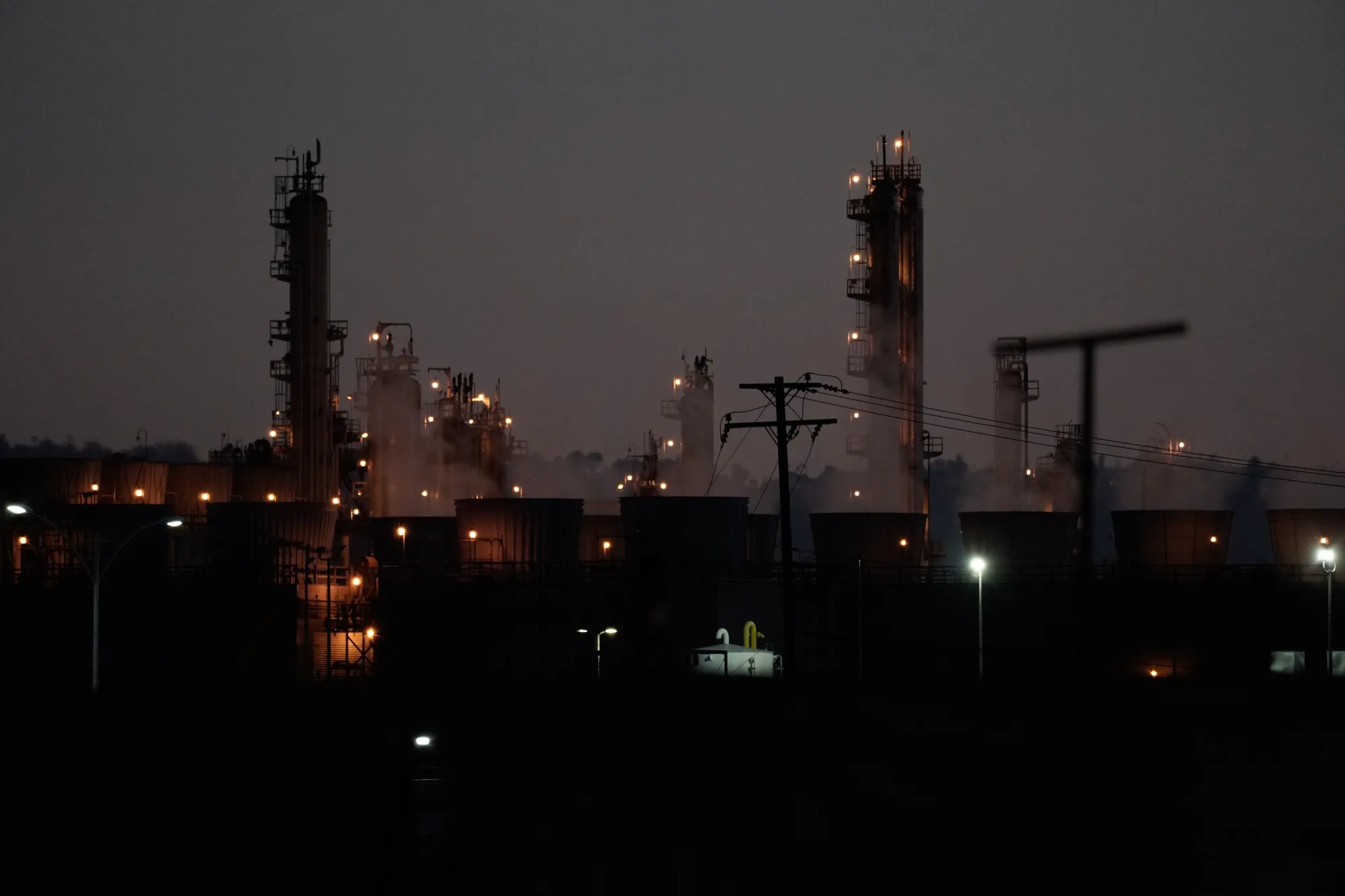 Distillation towers stand at dusk at a refinery in Wilmington, California on April 21.