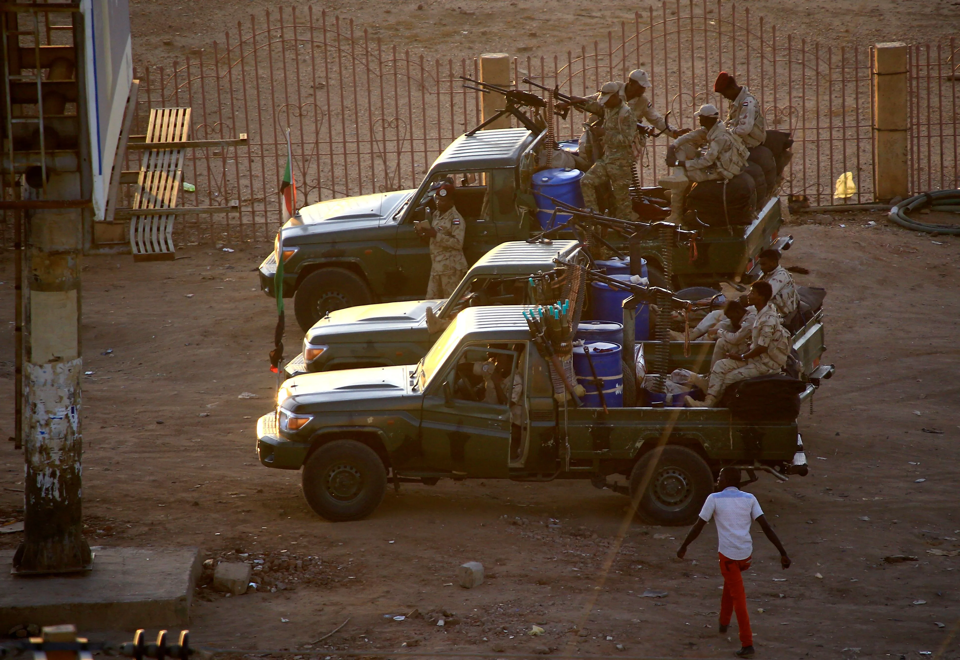 Members of Sudan’s security forces fire into the air at the headquarters of the Directorate of General Intelligence Service in Khartoum on Jan. 14.