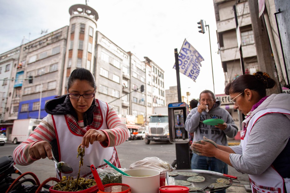 Lucero Montes de Oca and her daughter in law Pilar Ramírez prepare quesadillas and tlacoyos at her stand in López street.