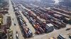 Shipping containers stand in a terminal in this aerial photograph taken at the Yangshan Deep Water Port in Shanghai, China, on Friday, March 23, 2018. The trade conflict between China and the U.S. escalated, with Beijing announcing its first retaliation against metals levies hours after President Donald Trump outlined fresh tariffs on $50 billion of Chinese imports and pledged there's more on the way.