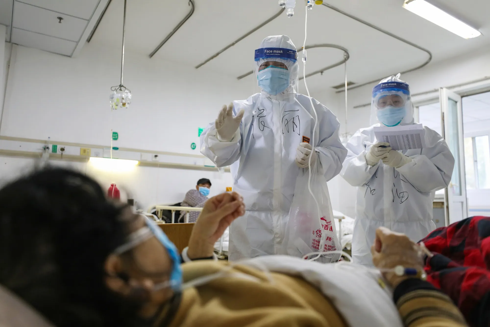 Medical staff check the conditions of patients in Jinyintan Hospital in Wuhan, Feb. 13.
