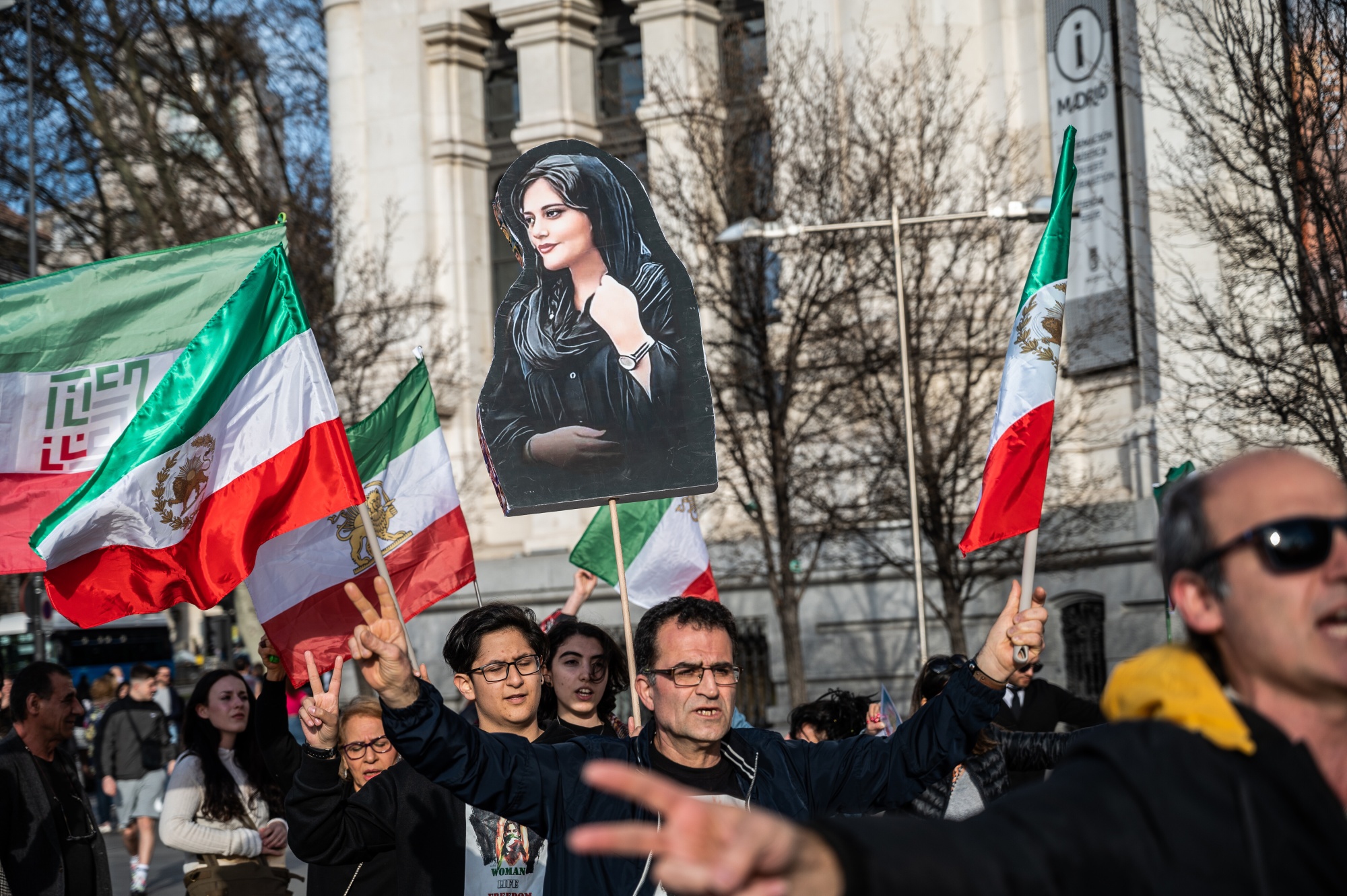Protesters carry a picture of Masha Amini during a demonstration in Madrid this March, one of many around the world following her death in Iran last year.&nbsp;