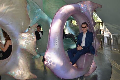 Adults ride the SeaGlass carousel.