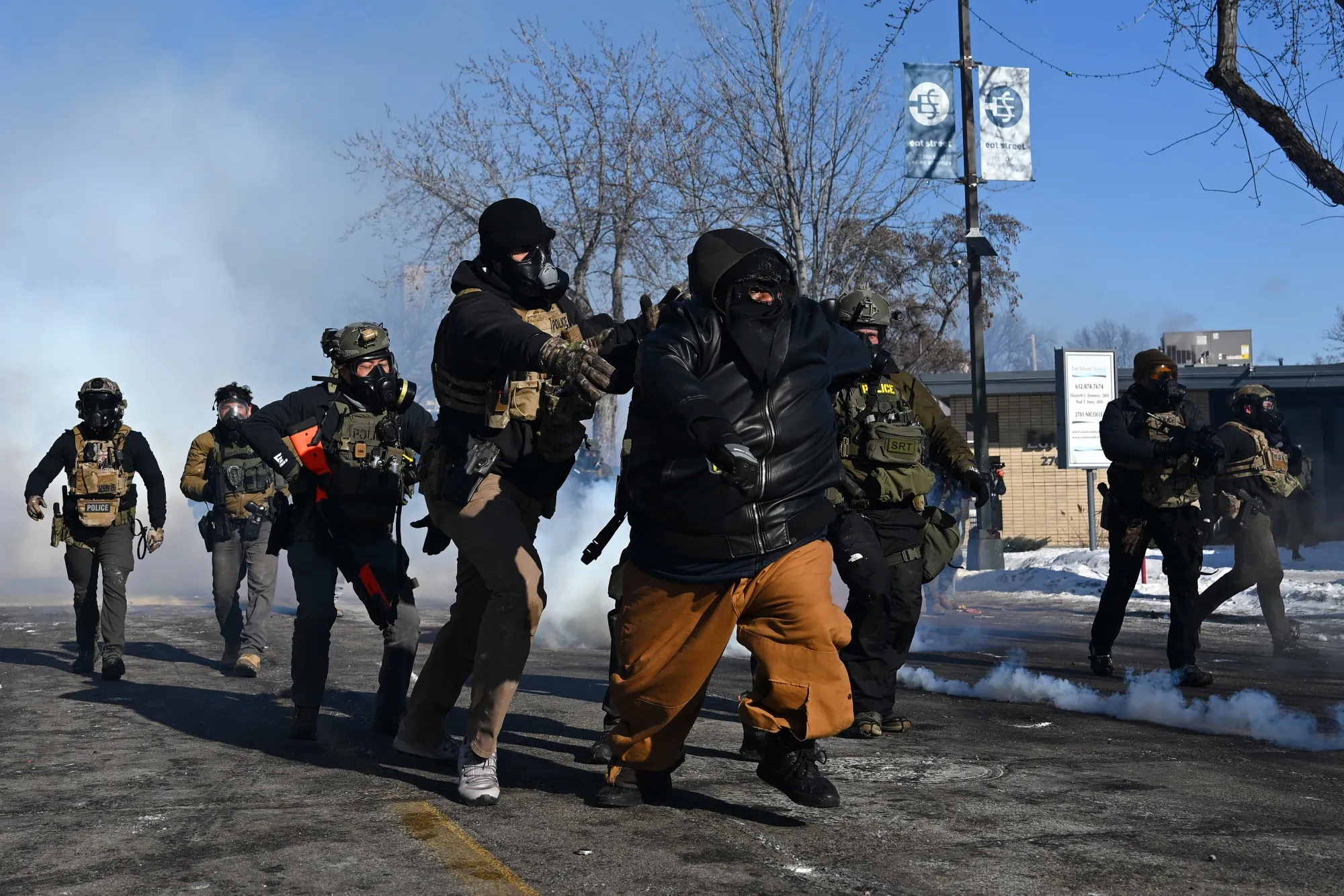 A&nbsp;person is chased by federal agents amid protests following a shooting&nbsp;in Minneapolis on Jan. 24.