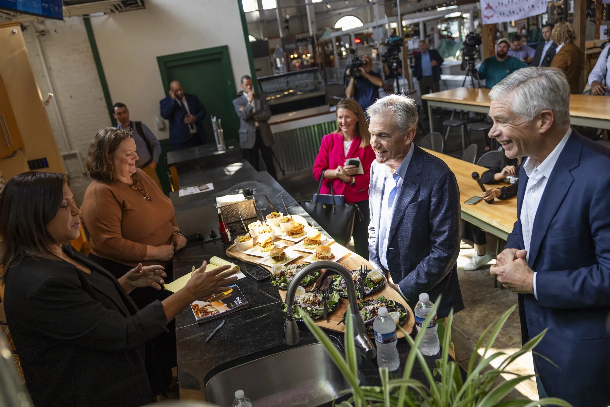 Patrick Harker, president and chief executive officer of the Federal Reserve Bank of Philadelphia, right, and Jerome Powell, chairman of the US Federal Reserve, second right, during a walking tour in the Central Market in York, Pennsylvania, US, on Monday, Oct. 2, 2023. 