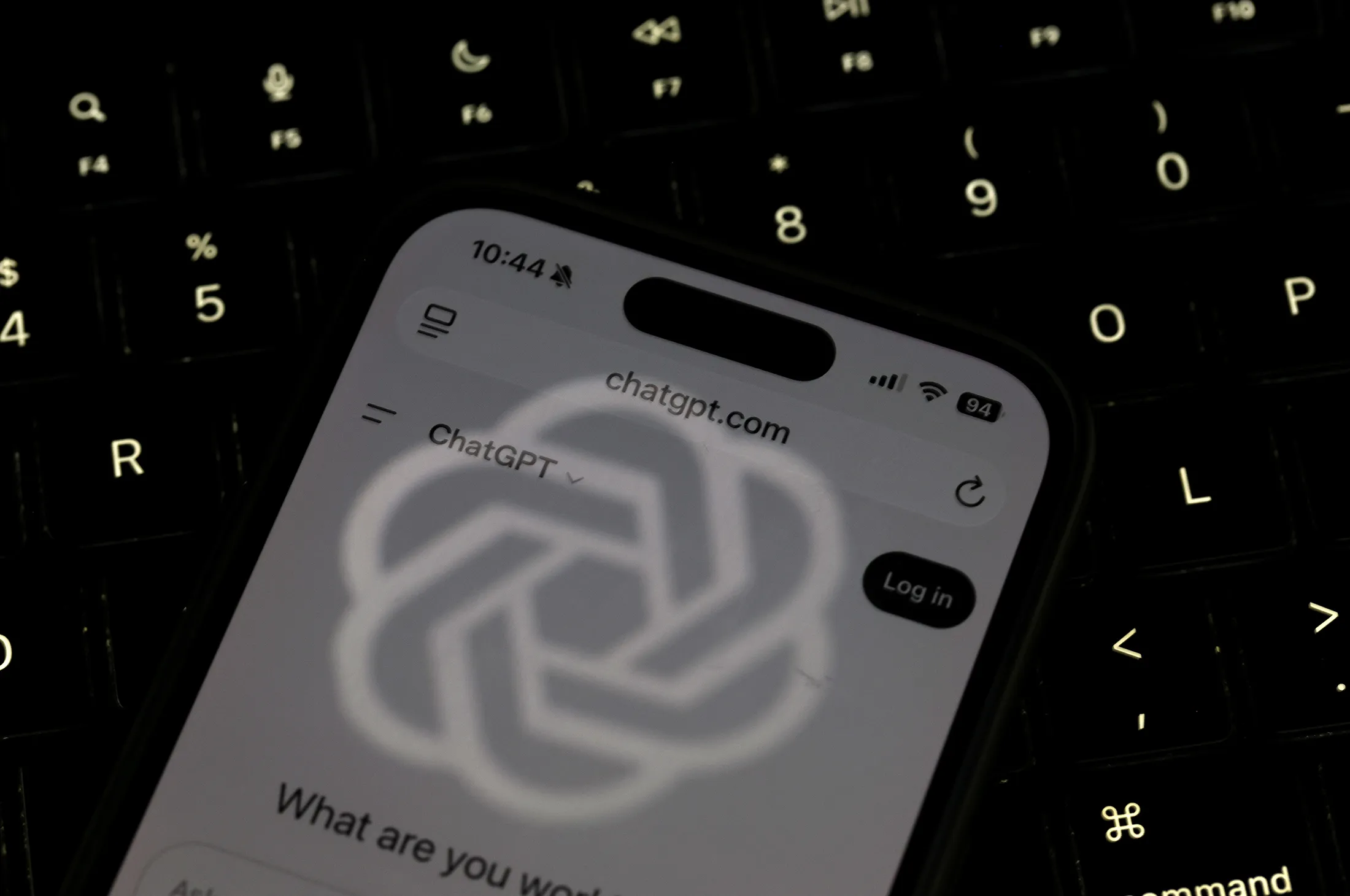 In this photo illustration, the OpenAI logo is reflected on the screen of a smartphone with the ChatGPT website displayed on May 20 in Los Angeles, California.