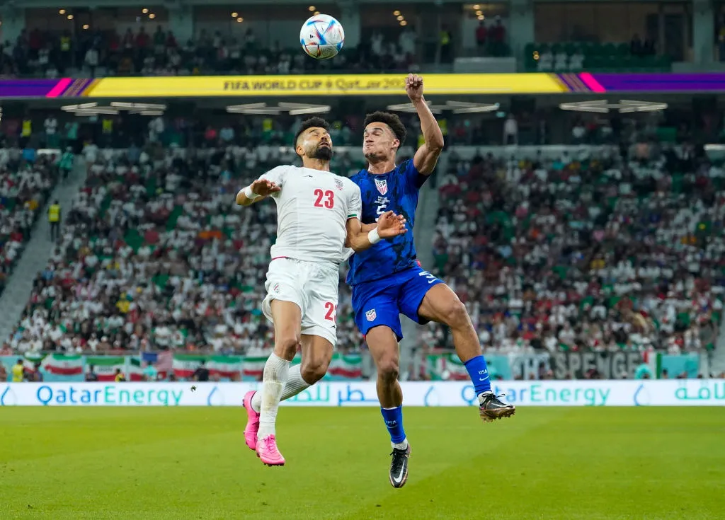 Players clash during a match between the United States of America and Iran at&nbsp;the FIFA World Cup 2022.