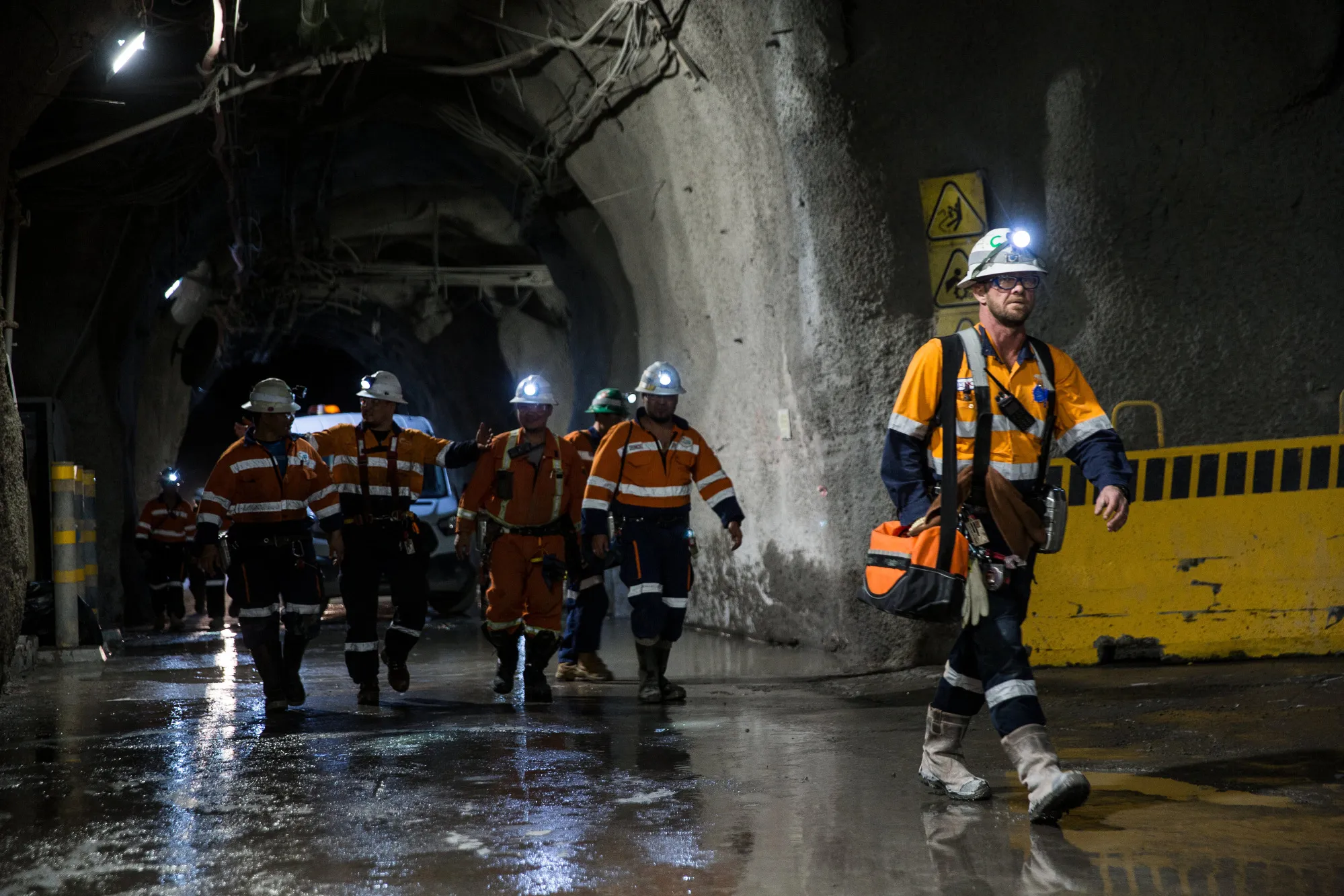 Workers walk through a tunnel towards elevators in the underground mining project at the Oyu Tolgoi copper-gold mine in Mongolia.