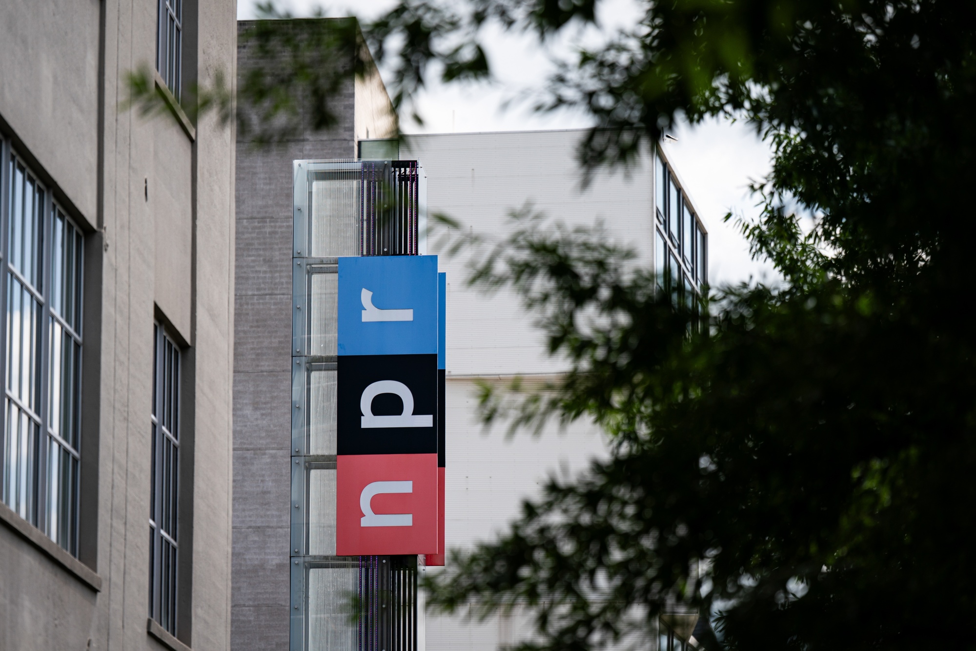 Signage outside the National Public Radio (NPR) headquarters in Washington, DC, US, on Thursday, July 17, 2025. Republicans are set to succeed in their decades-long quest to end federal funding for public broadcasting after the Senate passed a $9 billion package of cuts derived from Elon Musk's Department of Government Efficiency effort. Photographer: Al Drago/Bloomberg