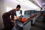 A flight attendant arranges a premium class seat of a Singapore Airlines aircraft.