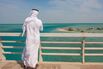 Rear view of a saudi man looking at the red sea from a bridge, Jizan Region, Farasan island, Saudi Arabia