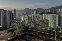 A man exercises on a hill overlooking apartment buildings in Kowloon, an area of Hong Kong where microflats have become increasingly popular.