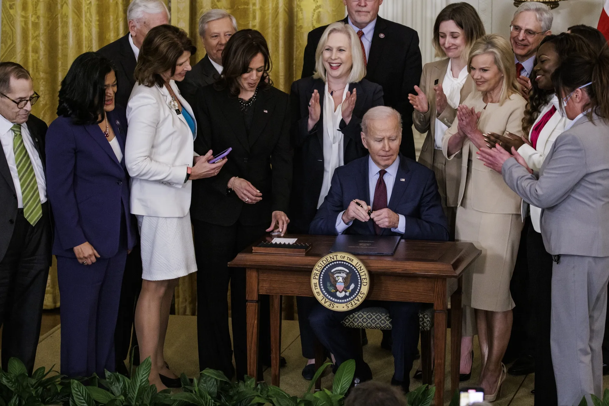 U.S. President Joe Biden signs the "Ending Forced Arbitration of Sexual Assault and Sexual Harassment Act of 2021," during a ceremony at the White House in Washington, D.C., U.S., on&nbsp; March 3. Congress delivered a major legislative victory for the #MeToo movement, passing the bill that guarantees victims of workplace sexual harassment or assault are free to pursue lawsuits in court.