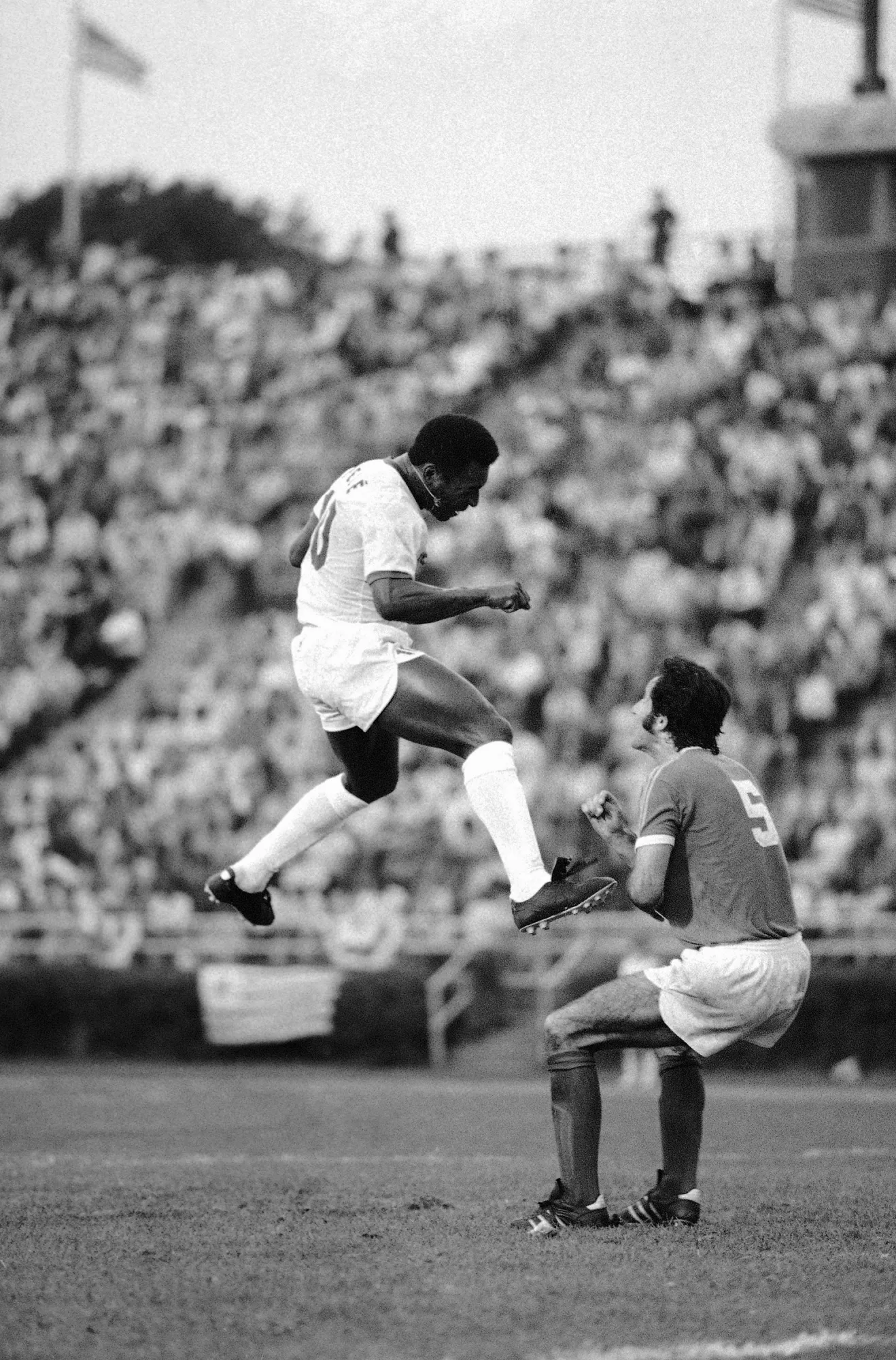 Pele reacts after heading the ball during a soccer match between the Cosmos and the Toronto Metro-Croatia in New York's Downing Stadium, June 19, 1975. Pelé, the Brazilian king of soccer who won a record three World Cups and became one of the most commanding sports figures of the last century, died in Sao Paulo on Thursday, Dec. 29, 2022. He was 82. (AP Photo/ Richard Drew, File)