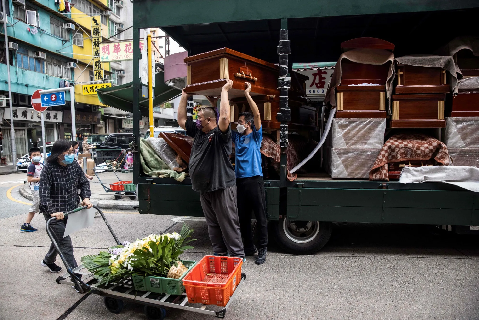 Empty coffins are delivered to a funeral services shop and funeral parlours in the Kowloon district of Hong Kong on March 17.