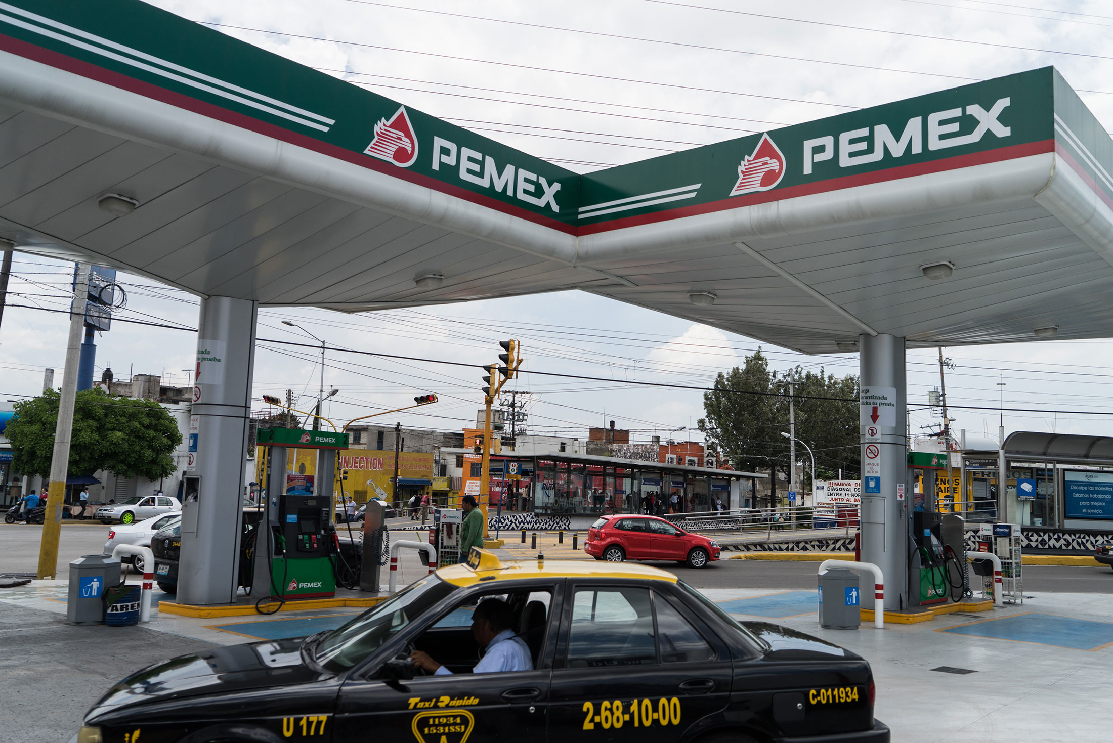 A taxi cab exits a Petroleos Mexicanos (Pemex) gas station in the city of Puebla.