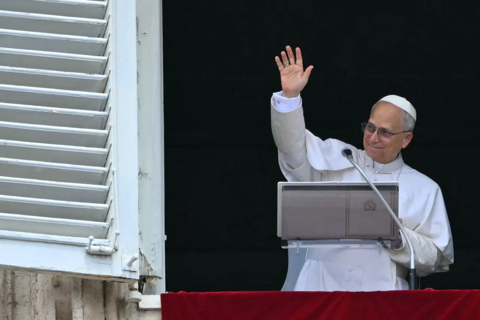 Pope Leo XIV waves from the window of the apostolic palace overlooking St. Peter's square on June 22, 2025.