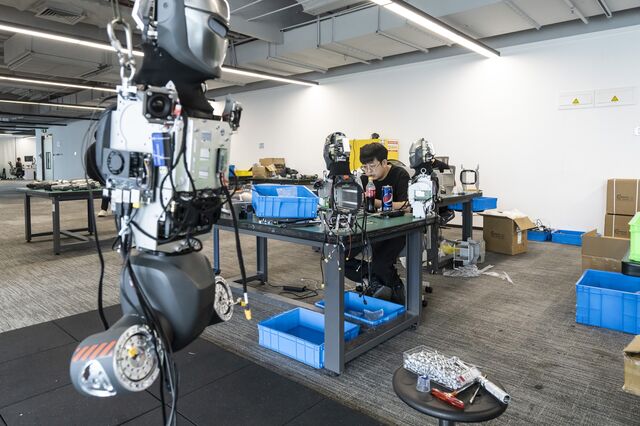 EngineAI PM01 humanoid robots being assembled at the company's workshop in Shenzhen.