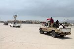 Fighters against Shiite Houthis gather in front of the airport in Aden, Yemen, on July 16, 2015.