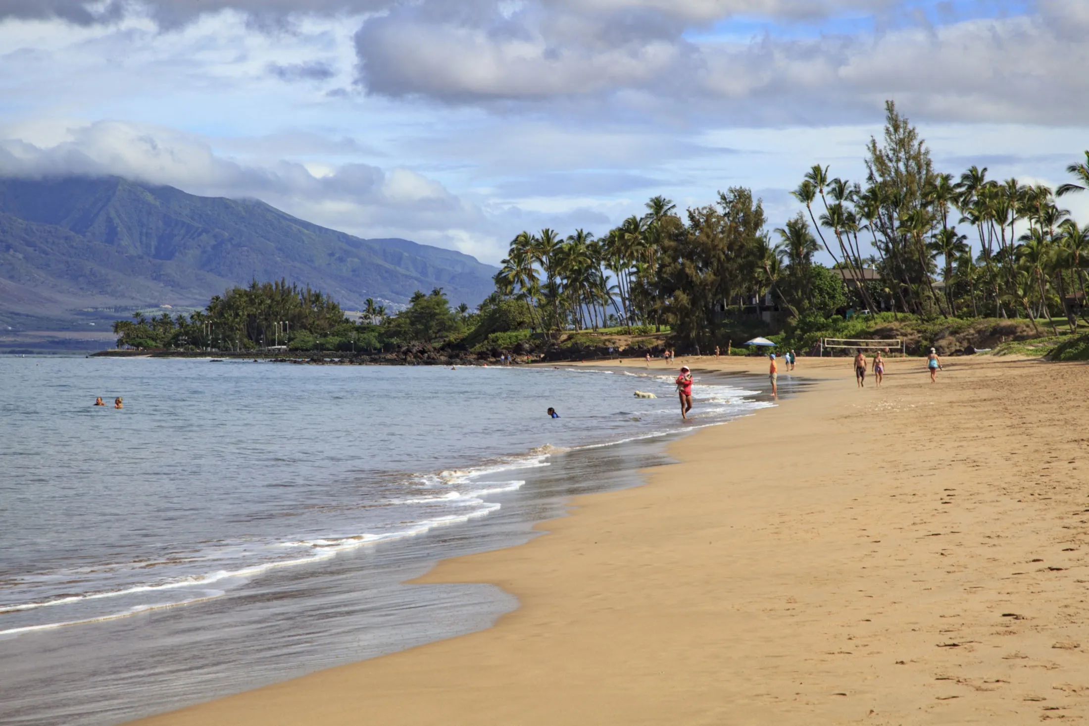 People visit a beach in Kihei, Maui County last August.