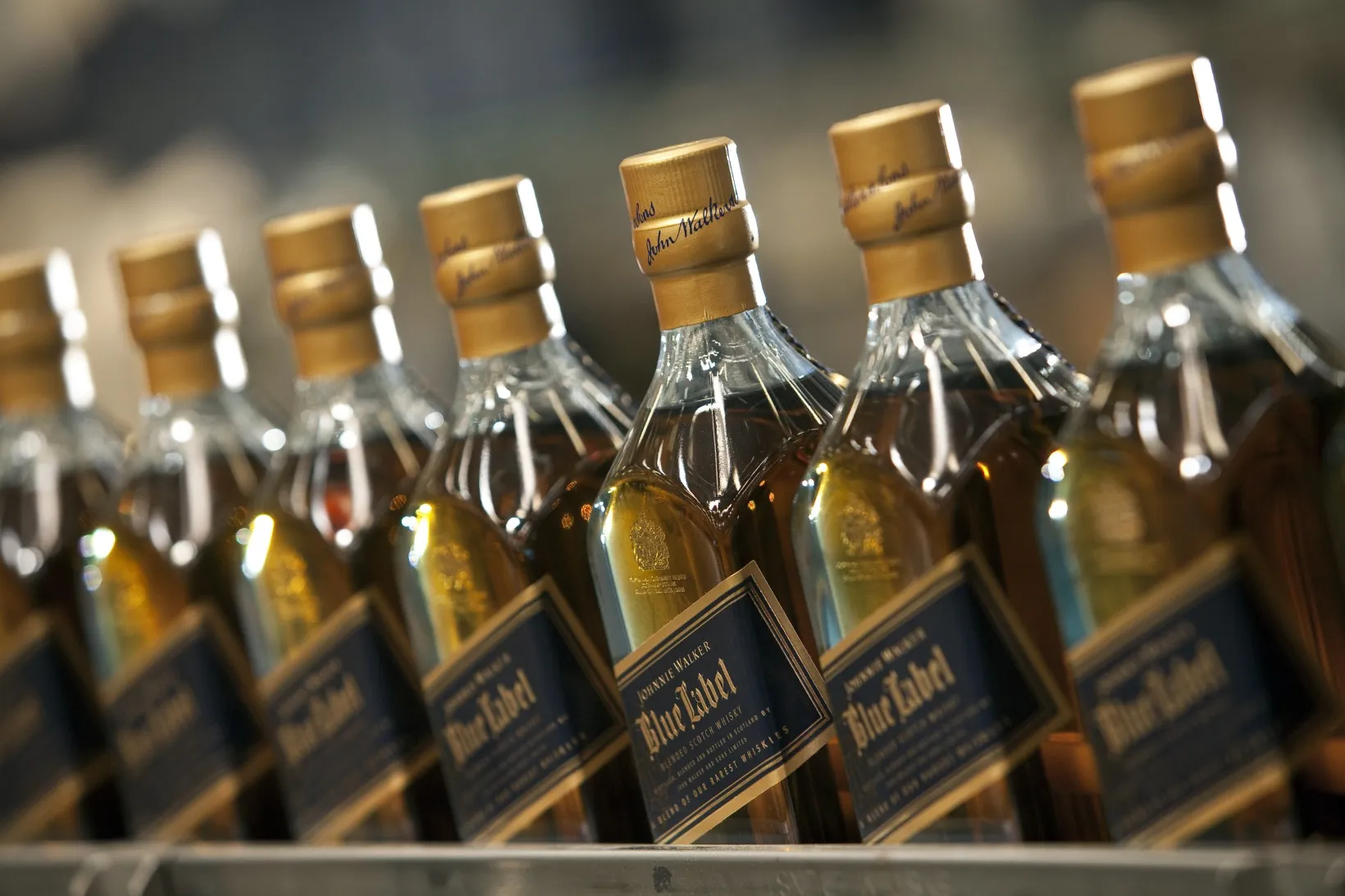 Bottles of Johnnie Walker Blue Label blended scotch whisky travel along the the production line at Diageo Plc's bottling plant in Leven, Scotland, on Wednesday, June 19, 2013. Diageo Chief Executive Officer Paul Walsh will step down in July, almost 13 years shaping the company into the world's largest distiller and hand over the reins to his chief operating officer Ivan Menezes.