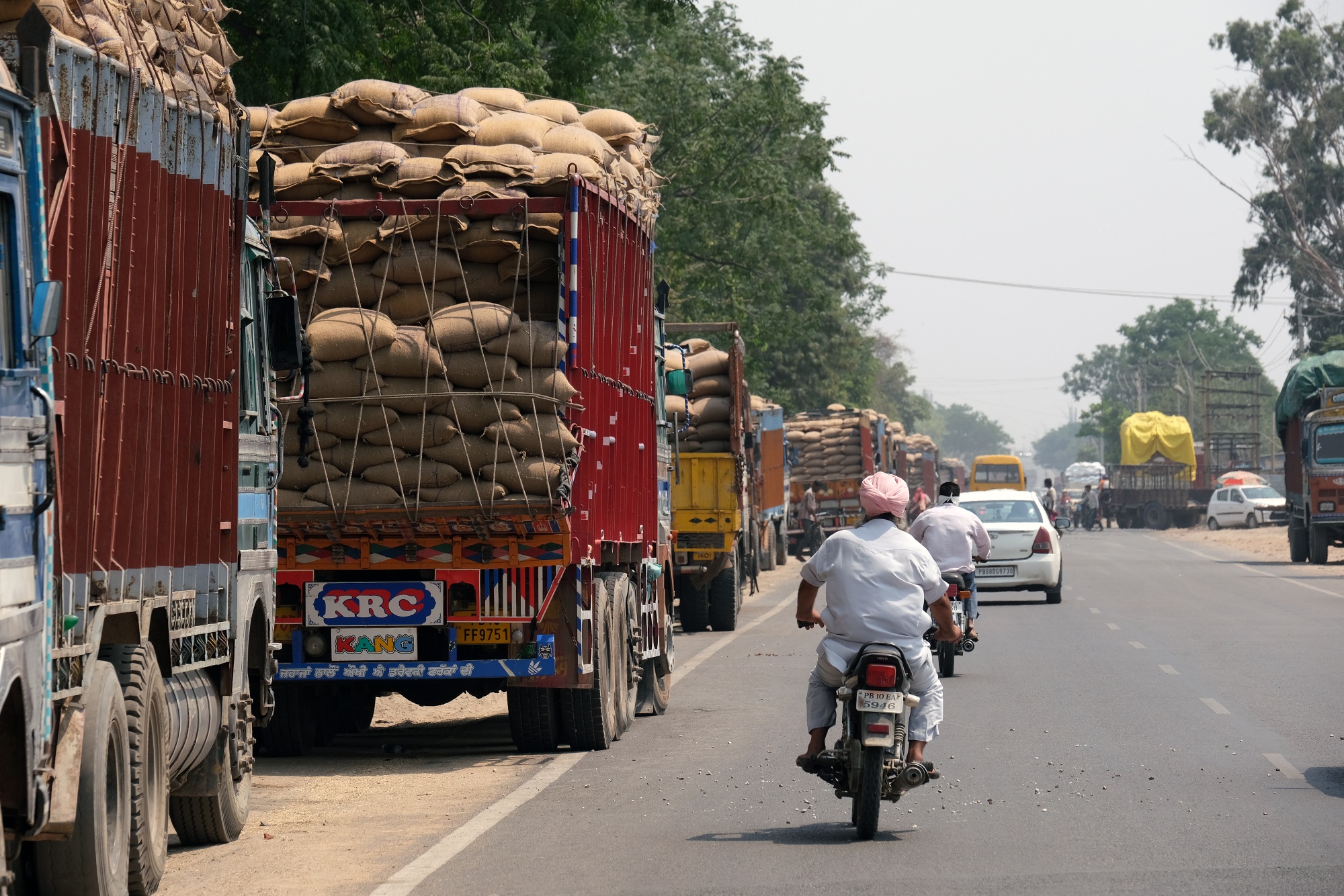 Loaded trucks along the road in Punjab.