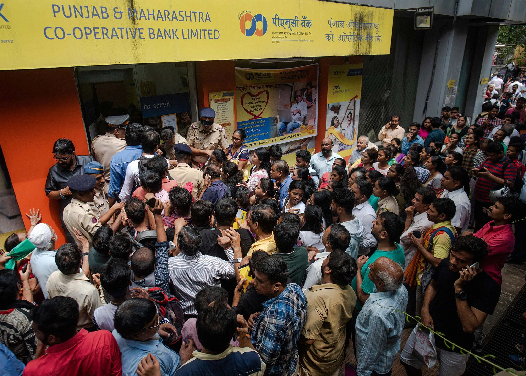 Account holders line up at a troubled co-op branch bank.