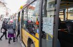 Passengers use a back entrance of a bus in Berlin on March 13.