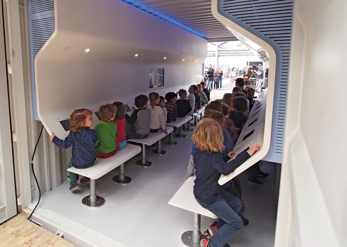 This demonstration unit in the Netherlands is outfitted as an education and communications center, with 20 touchscreen workstations.