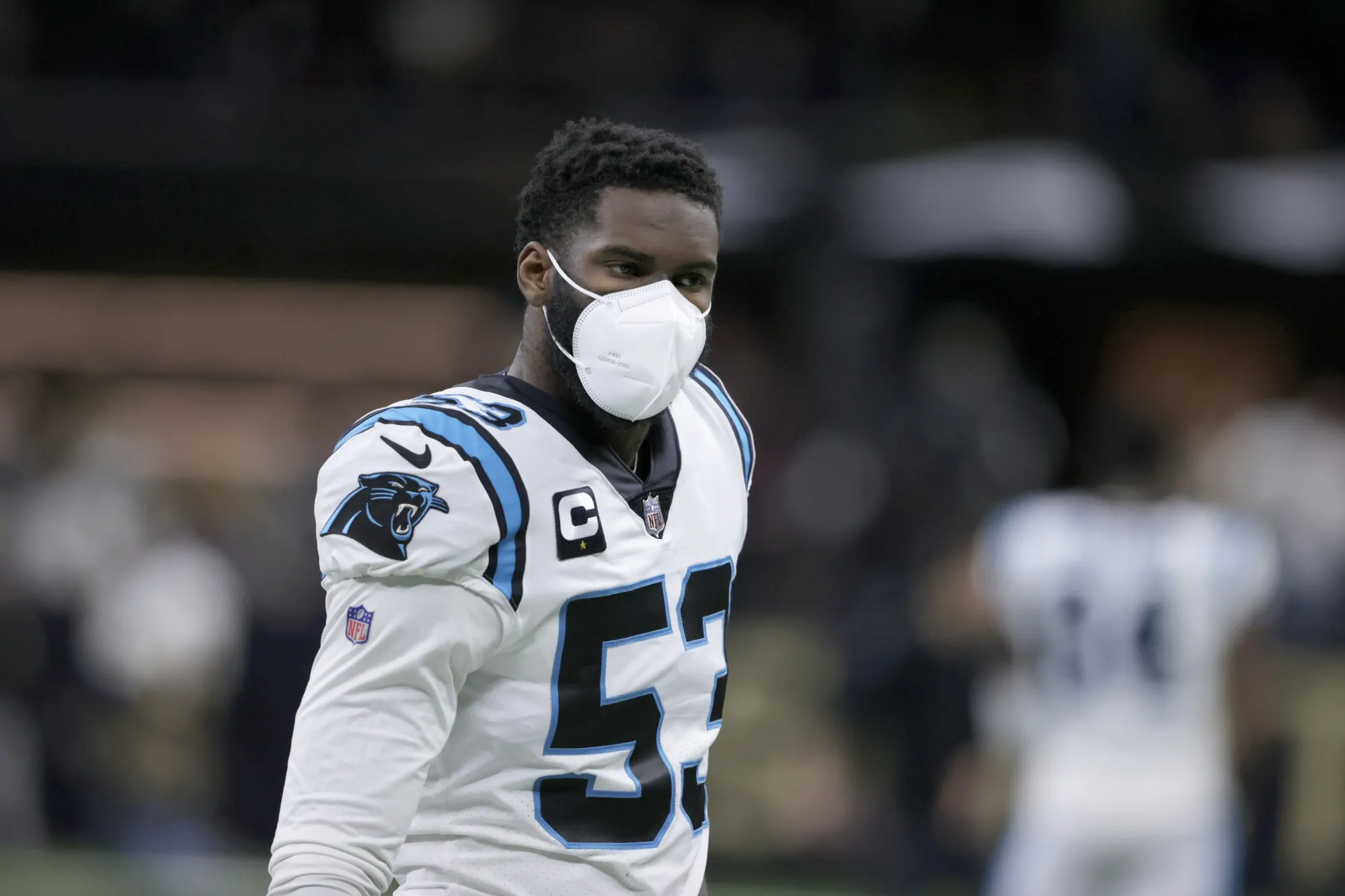 Carolina Panthers defensive end Brian Burns (53) wears a mask as he warms up before an NFL football game against the New Orleans Saints in New Orleans, Sunday, Jan. 2, 2022. The NFL has suspended all aspects of its COVID-19 protocols, citing recent trends showing that the spread of the coronavirus is declining. In an agreement with the players' association, the league sent a memo to the 32 teams Thursday, March 3, 2022, in which it mentioned “encouraging trends regarding the prevalence and severity of COVID-19, the evolving guidance from the CDC, changes to state law and the counsel of our respective experts” as reasons for the move.(AP Photo/Butch Dill, File)