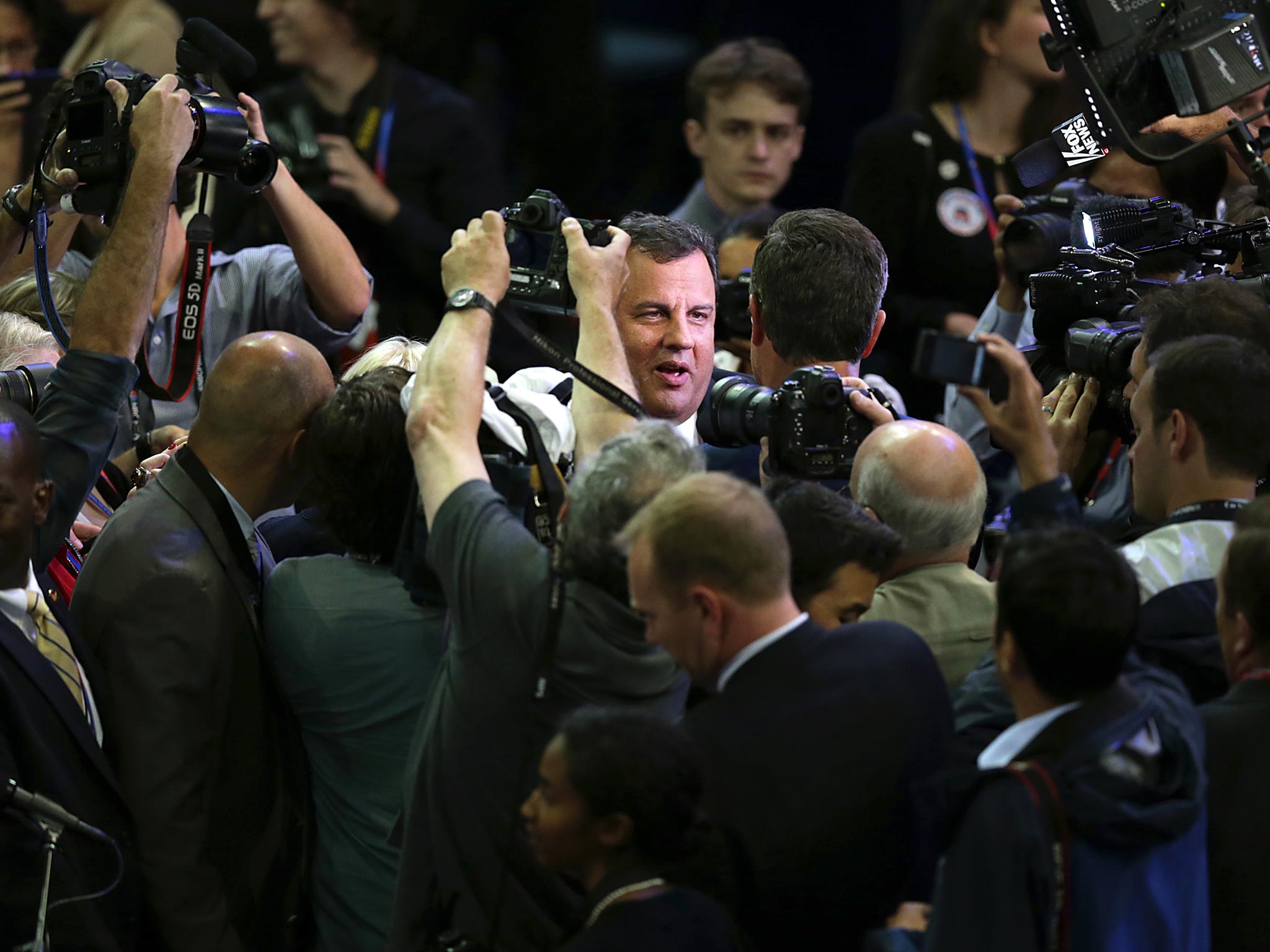 Chris Christie, governor of New Jersey, center, is swarmed by the media at the Republican National Convention in Tampa in 2012.