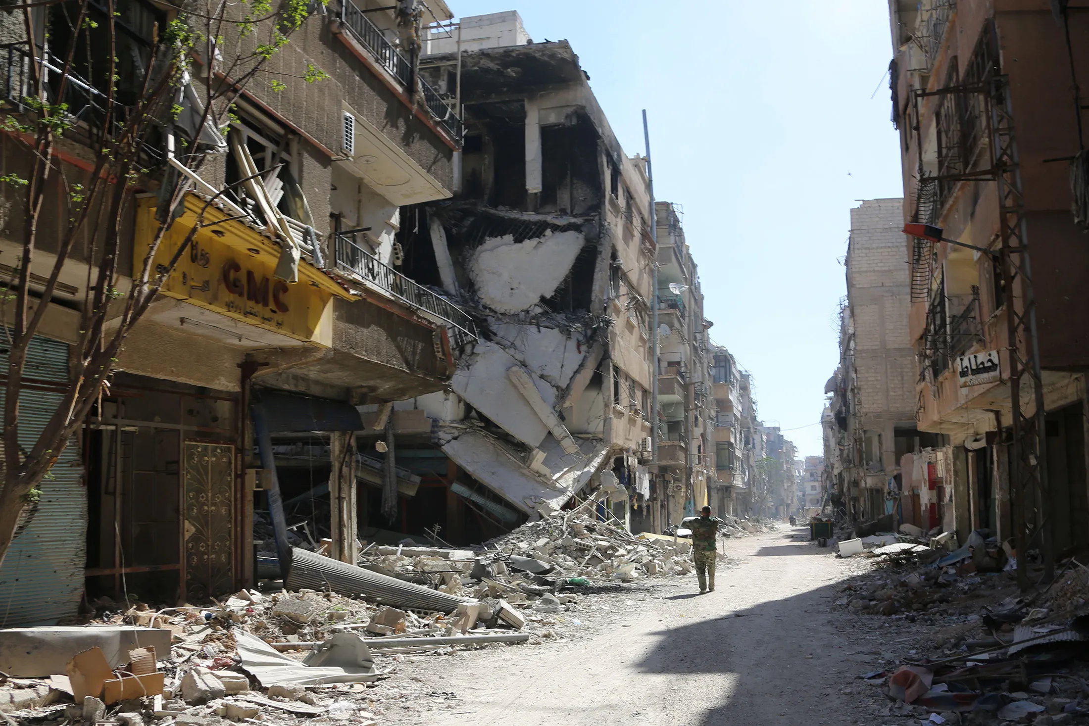 A Syrian soldier walks through&nbsp;Eastern Ghouta on March 26.