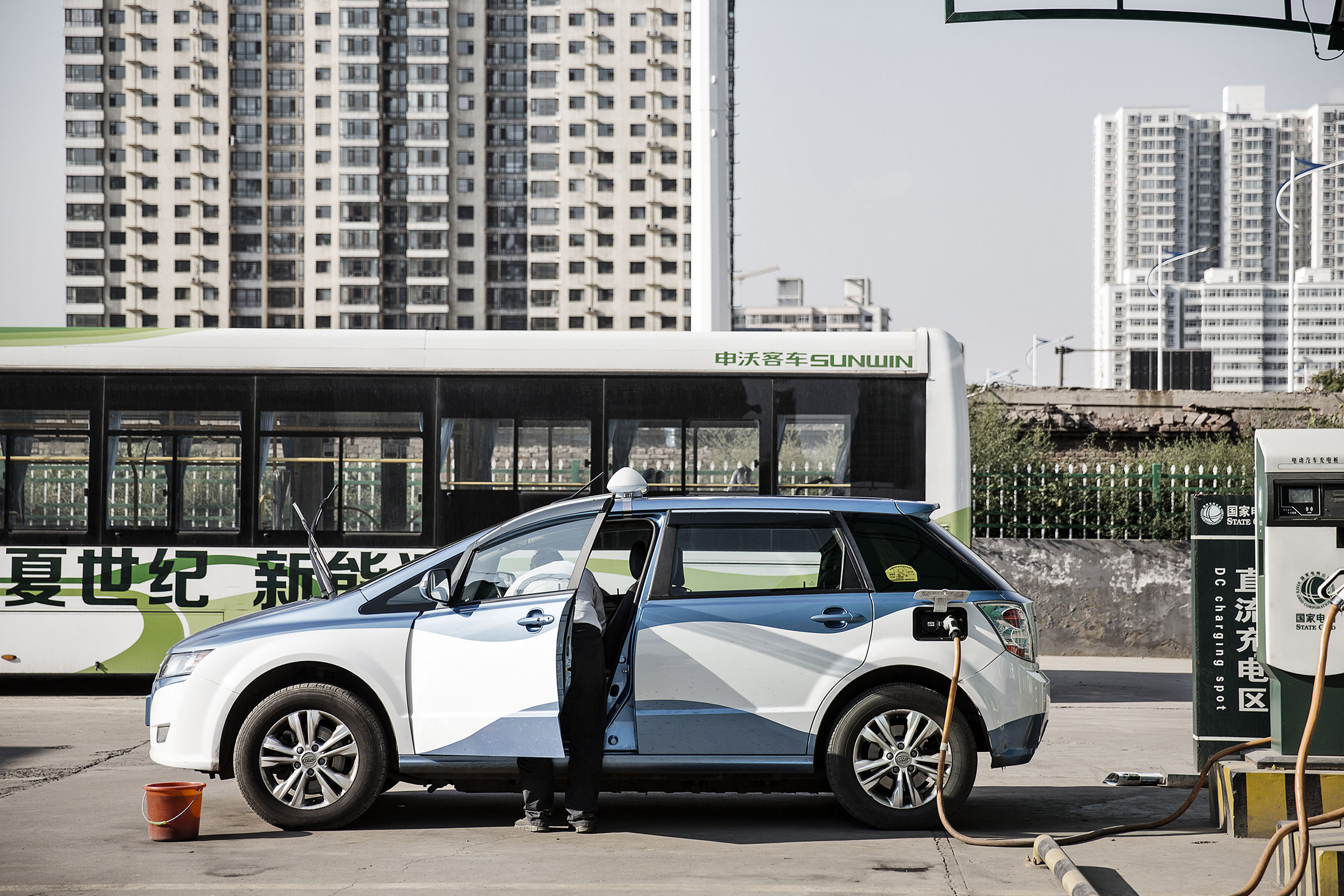 A BYD E6 electric taxi stands plugged to a State Grid charger in Taiyuan, Shanxi province.
