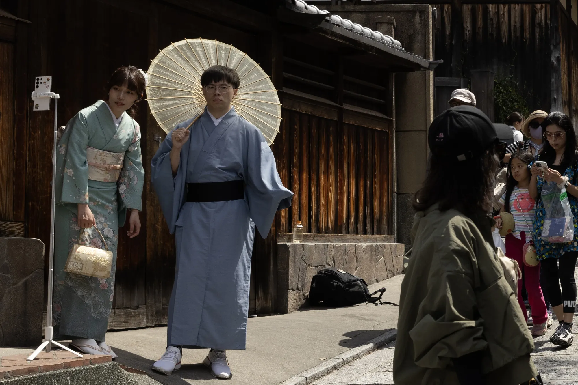 Kimono-clad visitors take a selfie photograph in Kyoto.