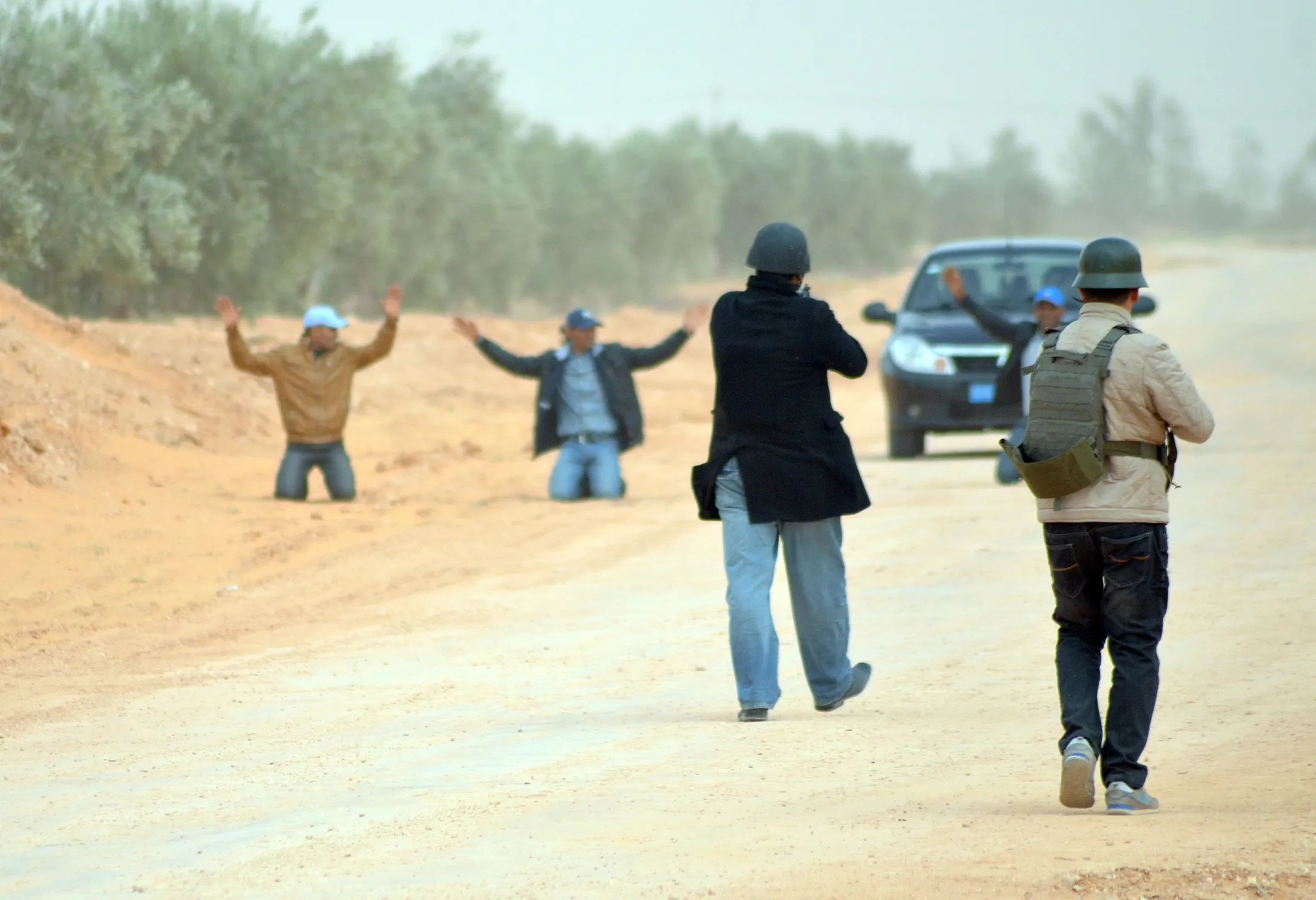 Members of the Tunisian police stop a car driving on a forbidden road near the Libyan border in Bouhamed, 40 km from the town of Ben Guerdane on on March 10, 2016.
