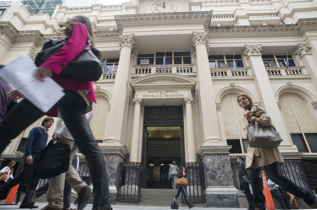Pedestrians walk past the Central Bank of Argentina in Buenos Aires.