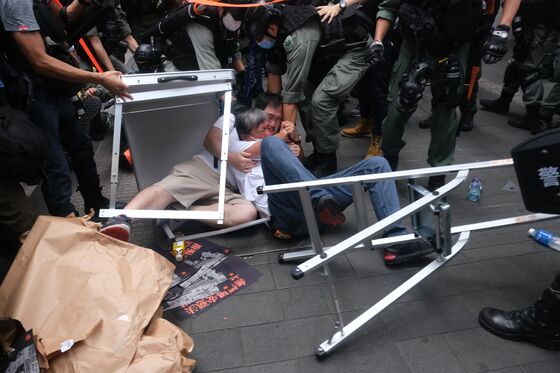 Hong Kong Files First Charges Under New Law, Bans Rallying Cry