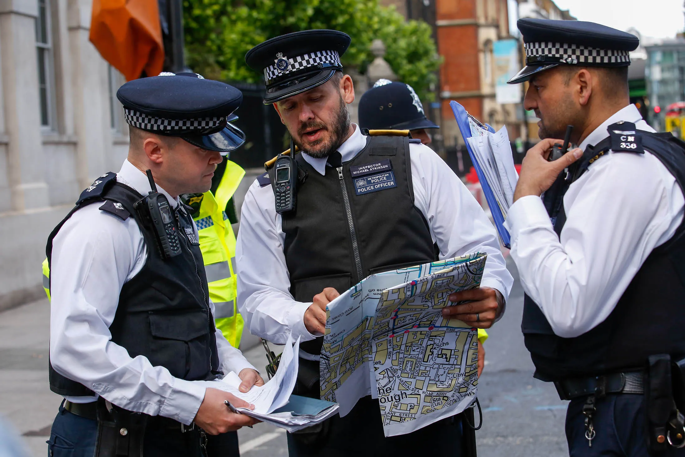 Police officers look at a street map near the site of the terror attack in London on June 4.
