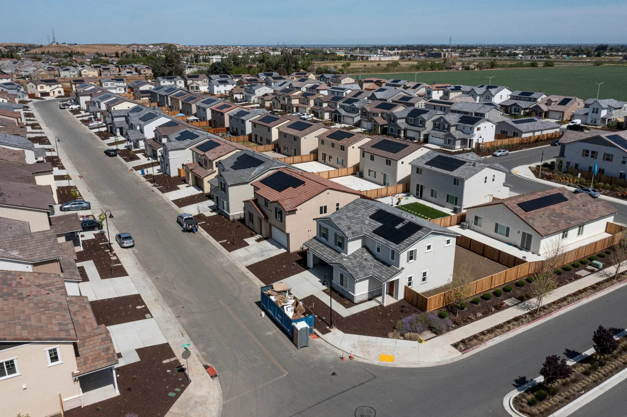 Urban development showing the growth of suburbs and city expansion around existing homes