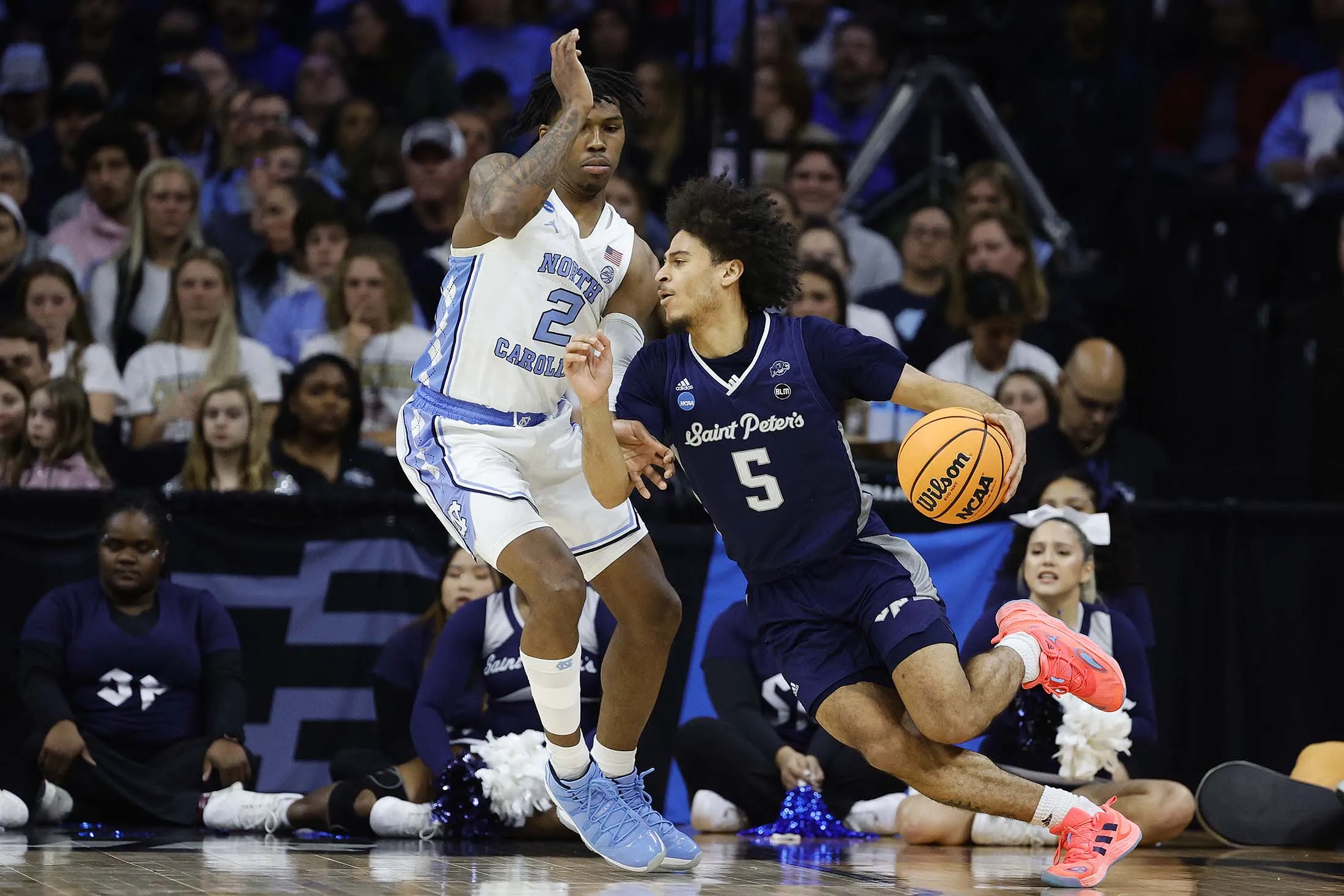 Daryl Banks III&nbsp;of the Saint&nbsp;Peter's Peacocks drives the ball past Caleb Love&nbsp;of the North Carolina Tar Heels during&nbsp;the Elite Eight round game of the&nbsp;NCAA tournament on March 27.&nbsp;