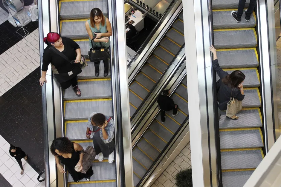 Shoppers ride escalators at the Beverly Center mall in Los Angeles, California. 