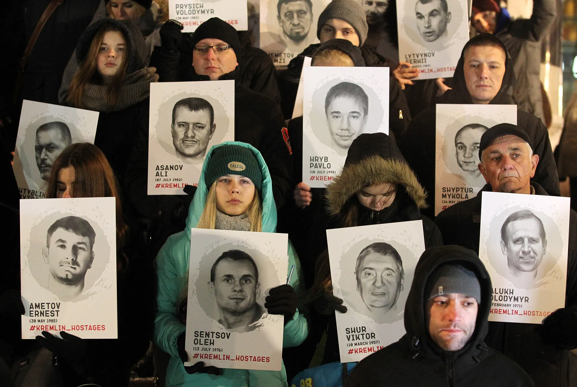 Ukrainians hold placards with portraits of Ukrainians during a rally in support of Ukrainian navy sailors.
