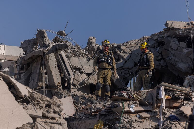 Israeli rescue forces search buildings hit during a ballistic missile attack by Iran, June 14, 2025.